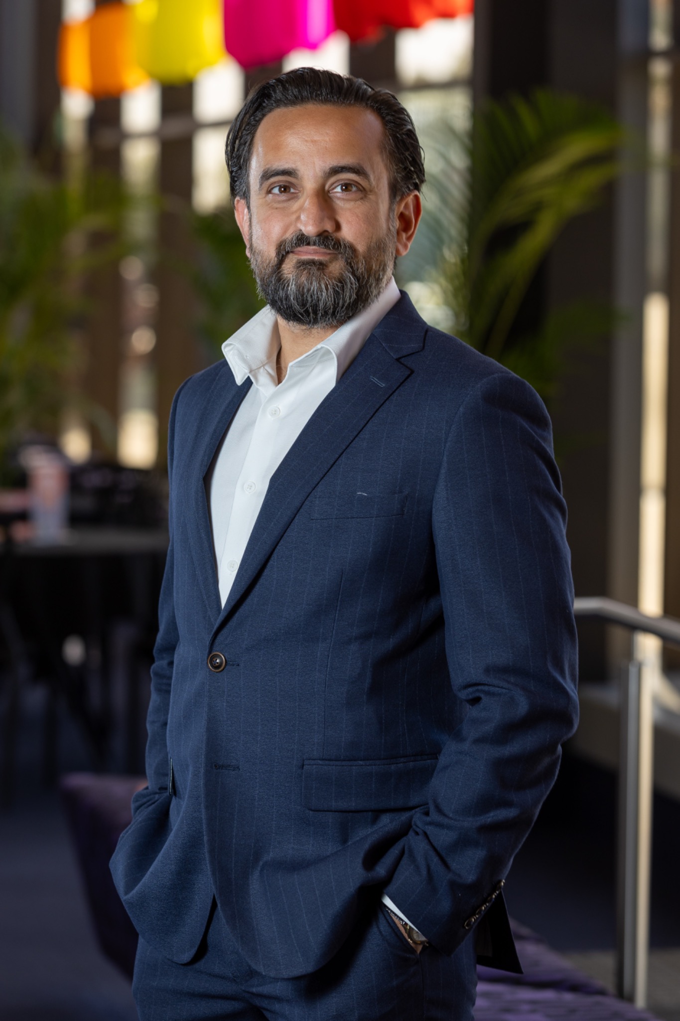Sami Shah in a navy suit, photographed by Ben Clark Imagery